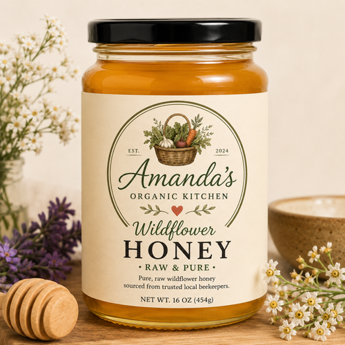 Jar of Amanda's Organic Kitchen wildflower honey with a label and natural elements in the background.